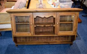 A Large Pine Wall Cabinet Rustic stained pine wall unit with two small glazed cupboards,