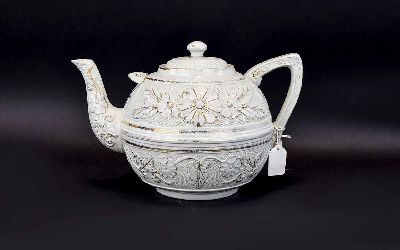 Large Cream Coloured Teapot with floral design and gold coloured marking.