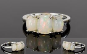 Opal Trilogy Ring, the central, elongated cushion cut opal flanked by two slightly smaller, similar,