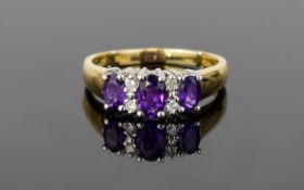 10ct Diamond And Amethyst Ring Set with three amethysts of good colour surrounded by multiple