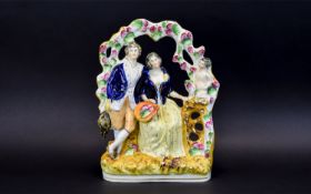 Staffordshire Arbour Group Figure of Two Lovers. c.1860. He Stands Wearing an Open Neck Shirt,