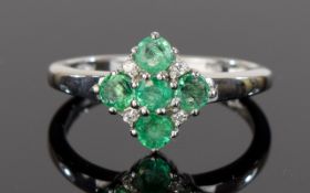 Emerald Cluster Ring, five round cut emeralds with four natural white zircon, totalling .