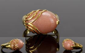 Peach Sunstone Caged Solitaire Ring, a 12ct oval cut cabochon of the gently glowing peach sunstone,