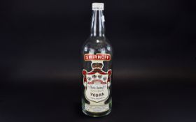 A Vintage 3 Litre Collectible Smirnoff Vodka Bottle Complete with original screw cap and label.