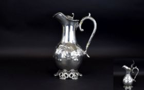 A 19th Century White Metal / Silver Plated Lidded Claret Water Jug with Scrolled Floral Decoration