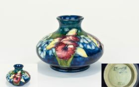 W. Moorcroft Signed Tube lined Squat Vase ' Orchids ' Pattern on Blue Ground. Signed W.