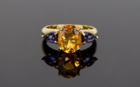 9ct Sapphire And Fire Opal Ring Gold ring with central statement faceted oval fire opal and small