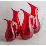 Whitefriars, four jugs, pattern 9419, ruby glass with clear handles, 21cm, 18cm, 17.5cm, and 12.