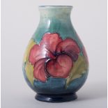 Walter Moorcroft, 'Hibiscus' a pear-shaped vase, circa 1950, the flowers against a sea green ground,