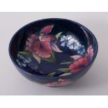 Walter Moorcroft, 'Orchid' a footed bowl, circa 1960, navy ground, stamped Pottery mark,