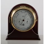 A ship's modern wall-mounted brass cased barometer by Weather Master, on a mahogany plinth, 23.5cm.