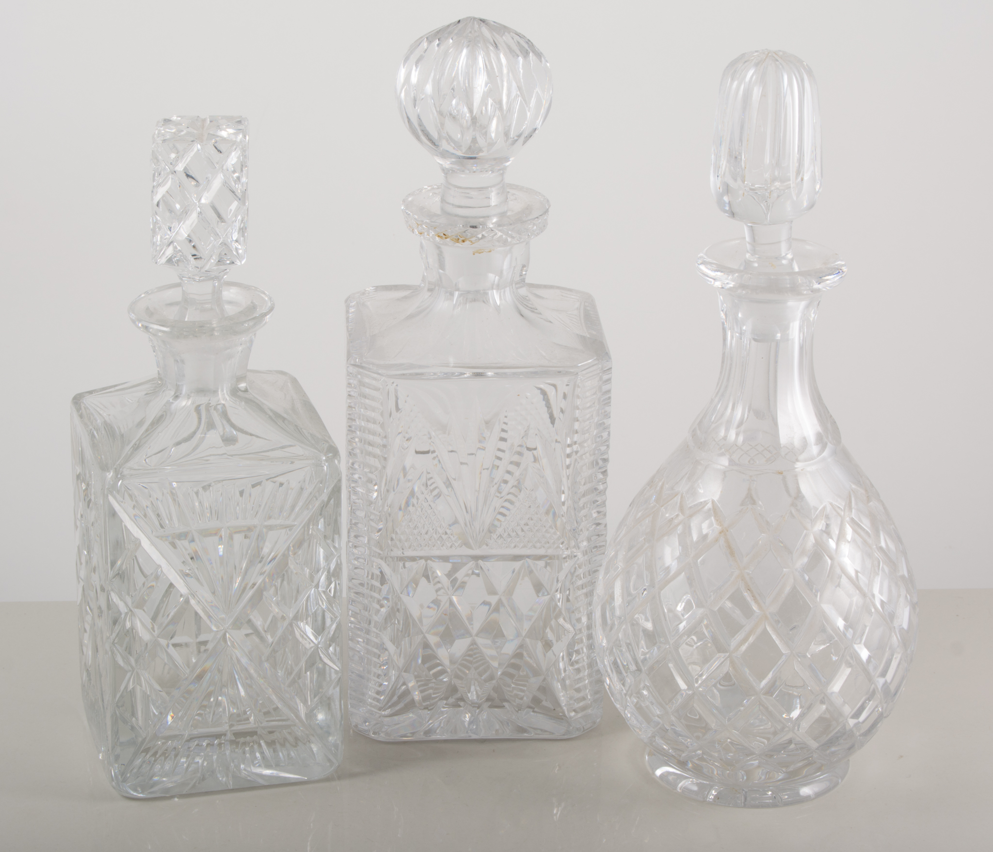 Collection of cut glass decanters, some lacking stoppers, (10).