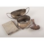 A silver caddy spoon with shell bowl, silver book match holder with engine turned pattern,