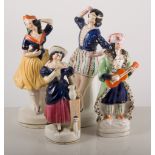 Staffordshire figures, two dancers, 25cm tall, a man with guitar and a woman with jug,