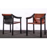 A set of nine black lacquered arm chairs, circa 1980, downswept arms with black leather arm pads,