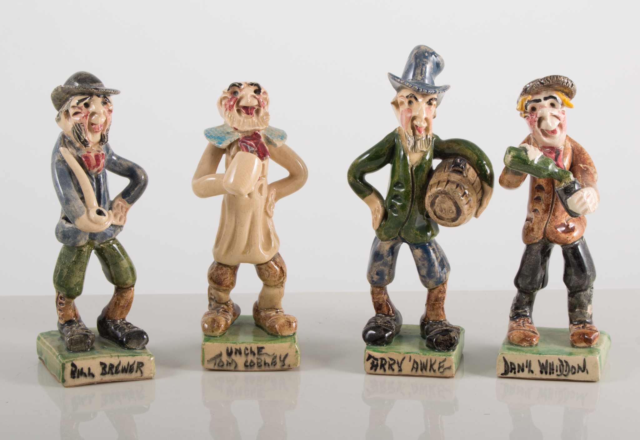 A collection of eight Will Young, Runnaford Pottery figures,