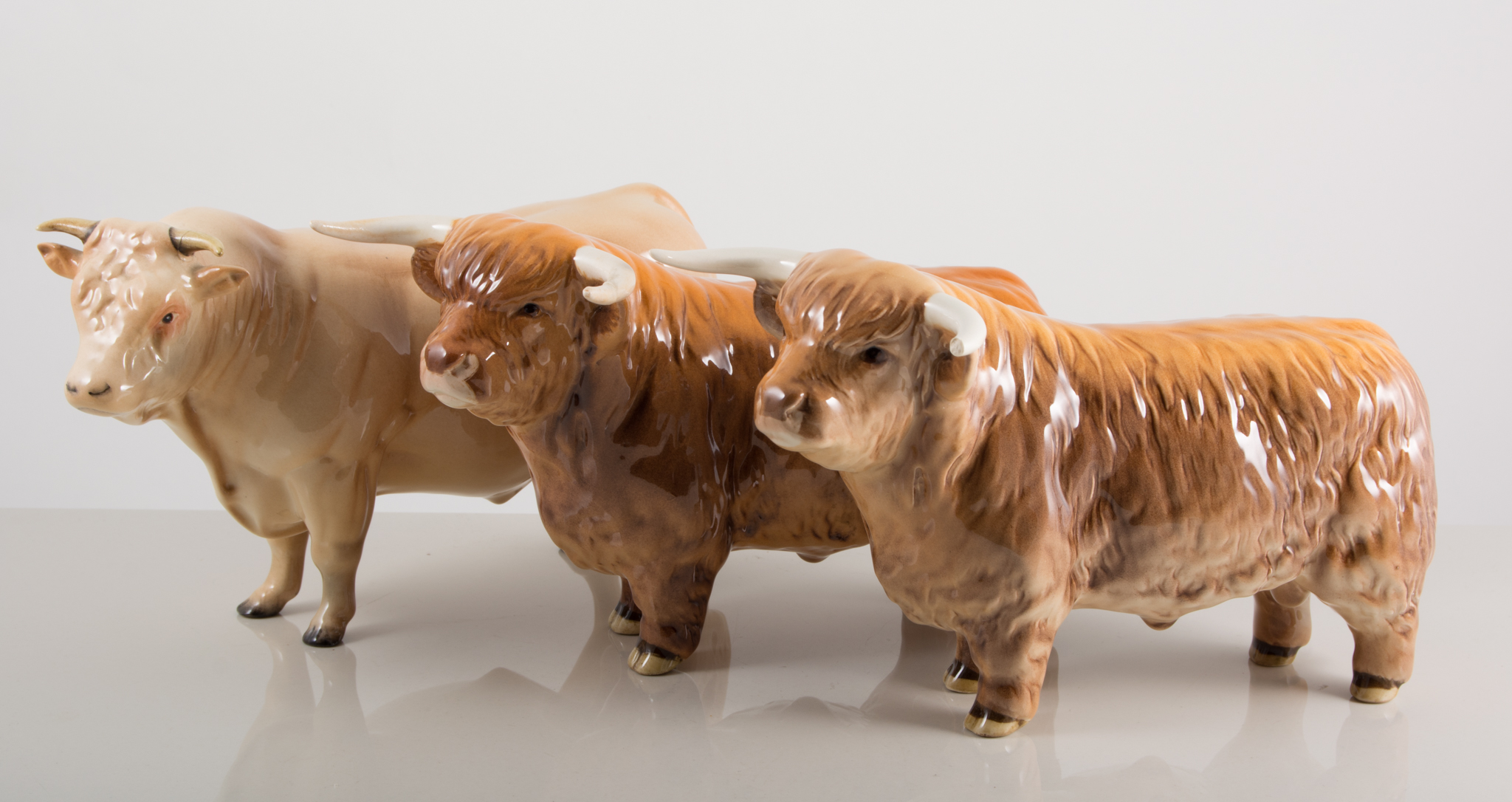 Beswick figures, two "Highland" bulls no.2008, 12cm tall, and another bull, all with damages, (3).