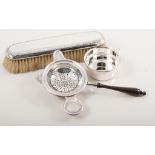 Two modern silver tea strainers, one having a stand, both by Francis Howard,