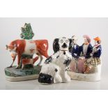 Staffordshire figures, Old Lang Syne, a large cow spill vase, pair of King Charles Spaniels,