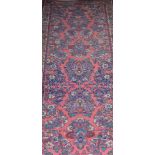 Persian pink ground runner, foliate field enclosed by borders, 295cm x 84cm.