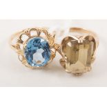 Two gemset dress rings, an oval faceted blue topaz 12mm x 10mm,