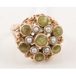 A peridot and pearl dress ring, seven circular peridot and six small pearls,