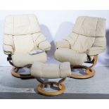 A pair of stressless cream leather armchairs, width 79cm, with matching footstools.