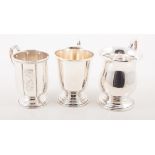 Three silver christening mugs, two with a plain polished finish, one with engraved panels,