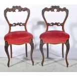 Pair of Victorian carved walnut balloon back chairs.