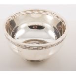 A circular silver pedestal bowl with a pierced leaf border on a similar single round foot, 7.