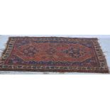 Hamadam rug, red ground with three tiles, floral border, worn, 148cm x 113cm; and a caucasian rug,