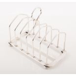 A silver six section toast rack, plain rectangular base, hallmarked Birmingham 1929,