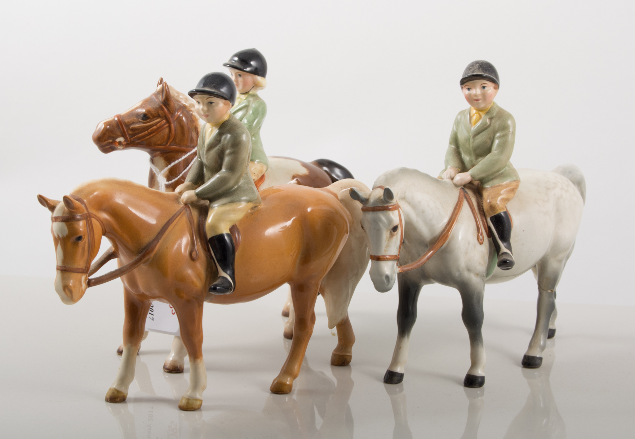 Beswick figures, Girl on a pony; Boy on a pony; and another Boy on a pony, 14cm.