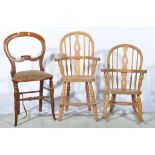 Two modern childs oak Windsor chairs, one with rocking base and a balloon-back chair, (3).