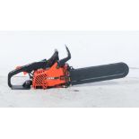 Echo CS-3050 petrol chainsaw, together with two extension leads.