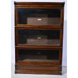 Three height oak sectional bookcase, by Globe Wernicke, applied labels, W87cm x D31cm x H129cm.