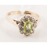 A peridot and diamond ring, the oval mixed cut peridot 7mm x 4.