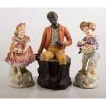 Continental china figure, black boy sat on a tree stump, height 30cm,