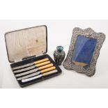 Box of miscellaneous items, including cuff links, three silver dessert spoons, photo frame,