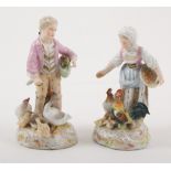 Pair of German porcelain figures, boy and girl feeding chickens, 14cm.