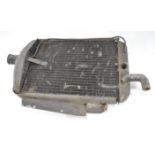 Original classic car parts, including a cylinder head, two half shanks, front radiator,