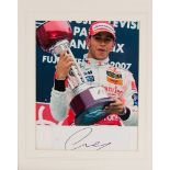 Framed signed photo of F1 racing driver Lewis Hamilton, 28cm by 32cm.