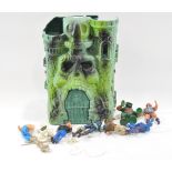 He-man castle, dating from the 1980s with small selection of action figures and accessories.