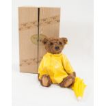 Steiff Mayfair teddy bear, dressed in yellow Mac with umbrella, boxed.