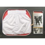 Joe Frazier signed boxing shorts, framed with photo, 98cm by 68cm, with certificate of authenticity.