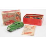 Schuco 3000 tin-plate telesteering car, green, with original box, skittles, key and booklet.