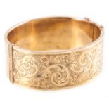 A hallmarked 9 carat yellow gold half hinged bangle,