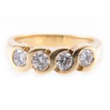A diamond four stone ring, the brilliant cut stones set in an 18 carat all yellow gold mount,