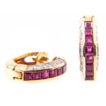 A pair of ruby and diamond half hoop earrings and a ruby cross,