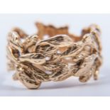 An 18 carat yellow gold dress ring in the contemporary style, 10mm wide open textured leaf design,